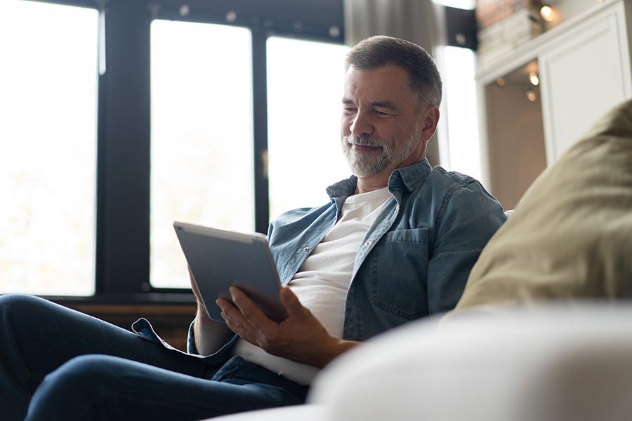 man looking at ipad